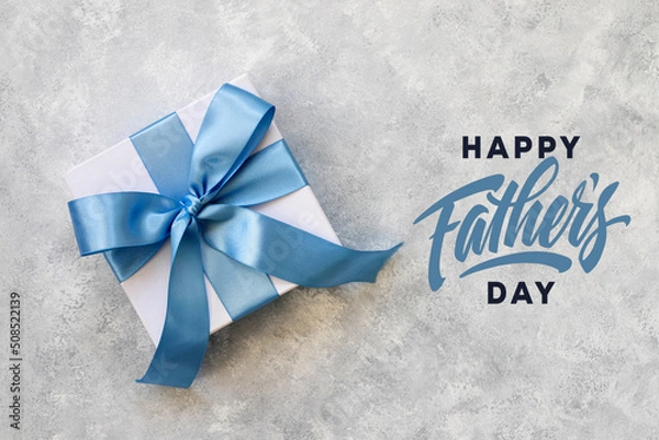 Fototapeta Design concept top view of Father's day gift idea with greeting on gray concrete background. 