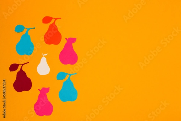 Obraz colorful paper pears arranged in a circle on the left side of the yellow background, creative summer design, copy space, colorful vitamin background, minimal concept