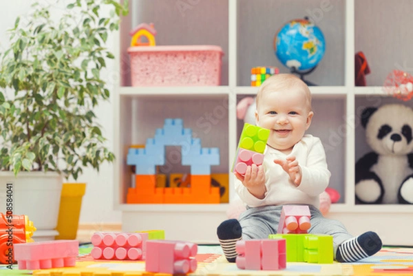 Fototapeta baby playing with colourful building blocks at home or kindergarten