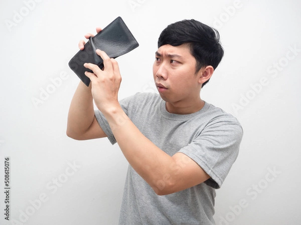 Fototapeta Poor man gesture find money in his wallet serious emotion