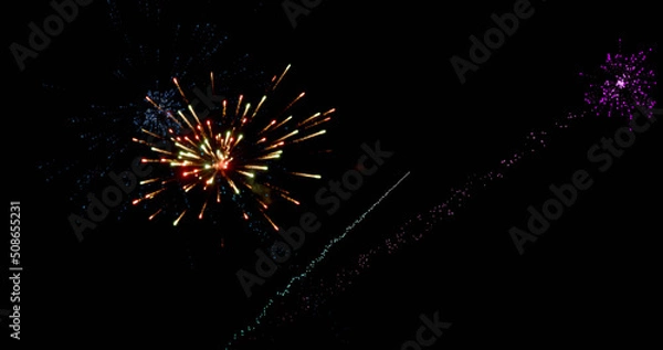 Fototapeta Image of colourful christmas and new year fireworks exploding in night sky