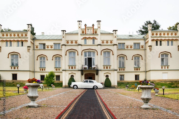 Obraz Exterior of a beautiful old house with white retro car