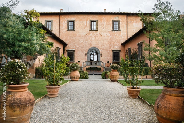Obraz Villa with rows of large pots with trees and flowers