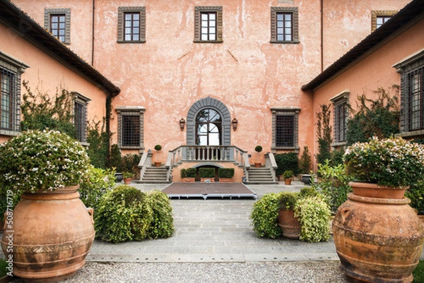 Obraz Villa with rows of large pots with trees and flowers