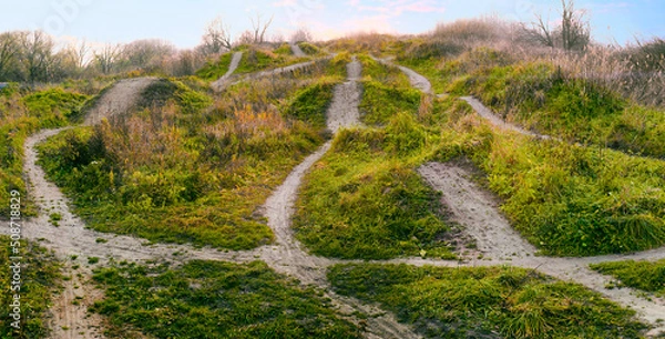 Obraz Many different paths and directions along dangerous uneven terrain. Winding paths and routes on green hills