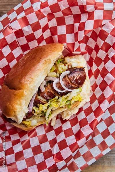 Fototapeta Top view of a hot dog in a takeout container