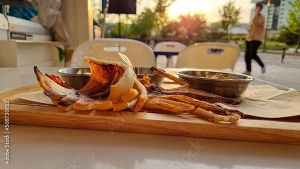Fototapeta Delicious squid snacks at sunset