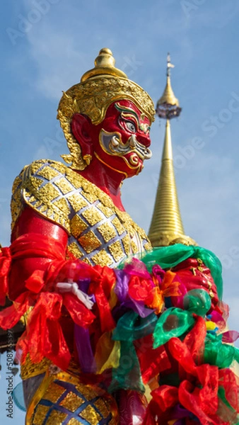 Obraz A giant red-colored statue guarding the temple.