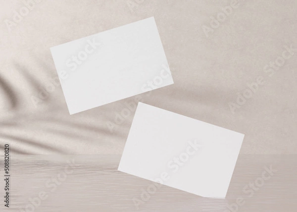 Fototapeta Blank white business cards with plants shadows on the cream background with water. Natural mockup for branding identity. Two cards to show both sides. Template for graphic designer. 3D rendering.