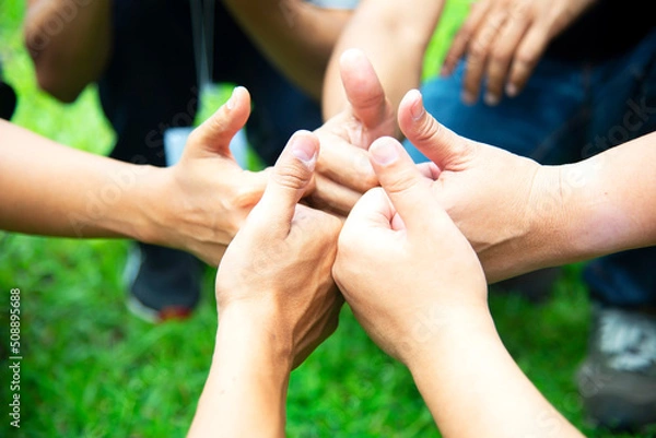Fototapeta Teamwork Hands of spirit team working together outdoor. Unity strong handshake with people or agreement of feeling or happy diverse education action