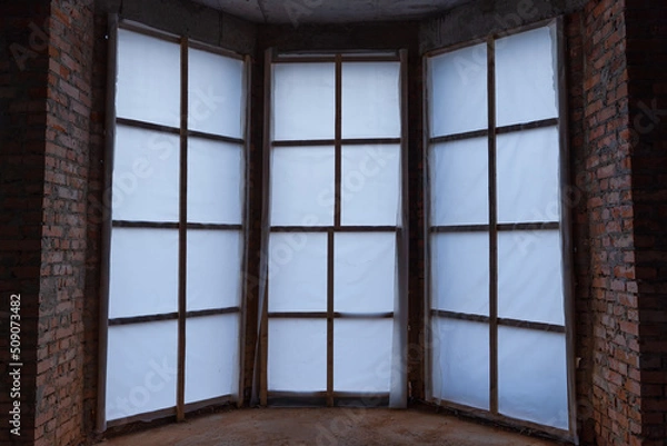 Fototapeta The entrance to an unfinished private house is sheathed with an opaque film, inside view
