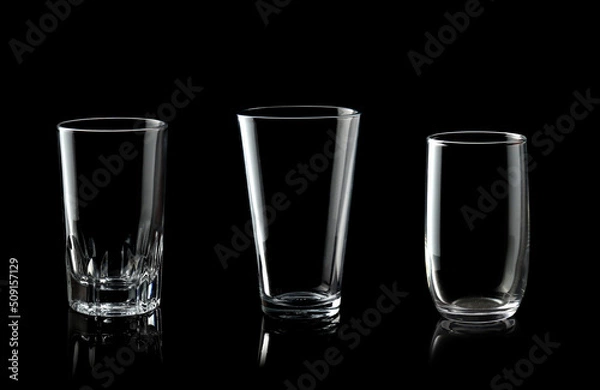 Fototapeta Set of empty glass of water isolated on black background