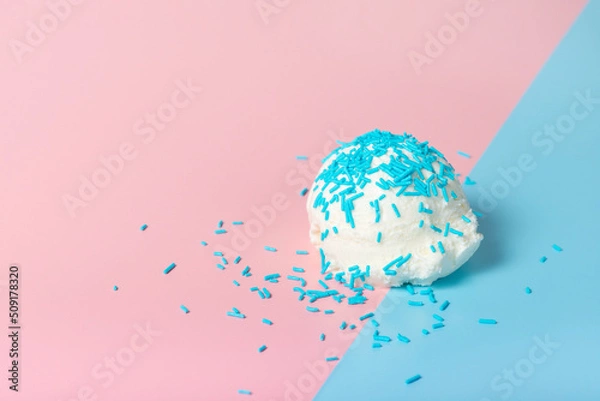 Fototapeta vanilla scoop of sundae ice cream strewed sprinkles on blue and pink background, close up