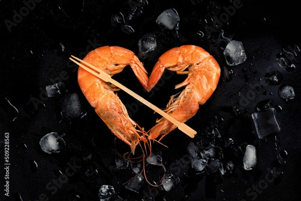 Obraz Cooked shrimps,prawns heart shape  on stone background with ice.Top view.Valentine's Day celebration.