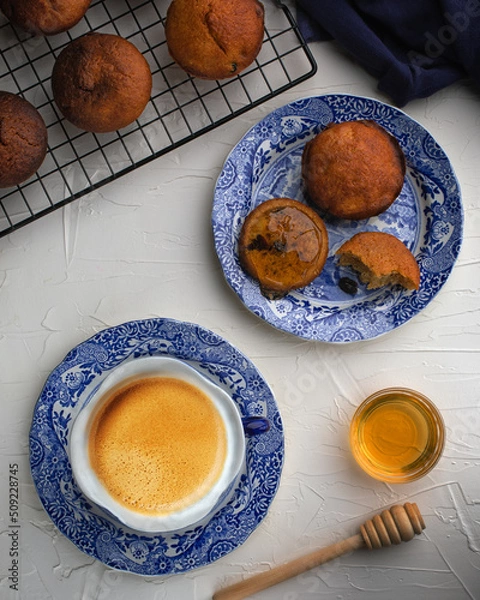 Obraz Muffins with raisins served with coffee and honey for restaurant on white background.Top view