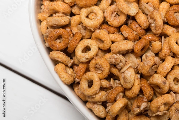 Obraz Heart Shaped Bowl of Cinnamon Flavored O Shaped Cereal and Oats