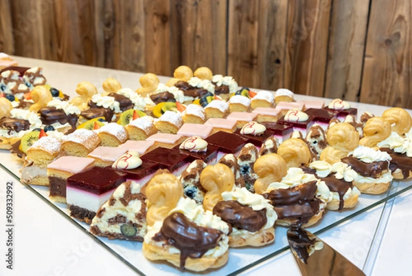 Fototapeta plates filled with pieces of different cakes