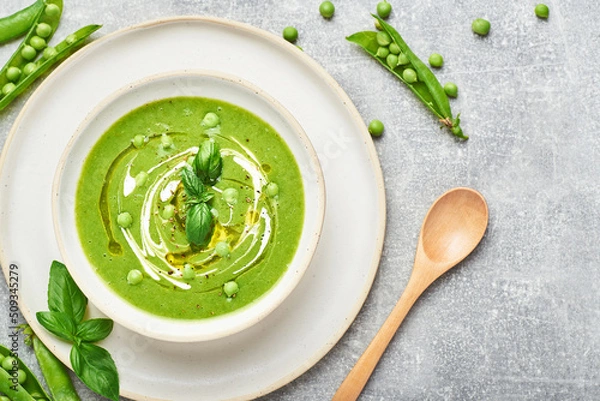 Obraz Green peas soup. Healthy vegan green peas soup served in bowl on rustic table.
