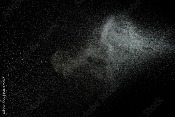 Obraz Sprayed water. Splashes and drops of water isolated on black background.