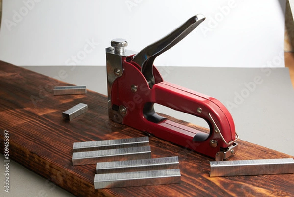 Obraz construction stapler with staples on the board