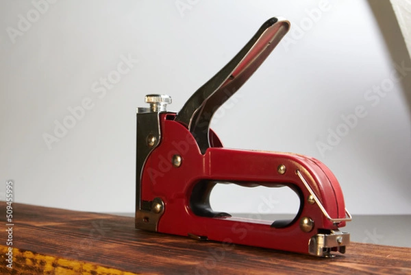 Obraz construction stapler with staples on the board