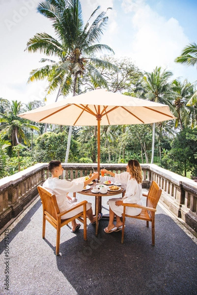 Obraz Young Couple Having Breakfast On The Terrace With The Jungle View In Bali, Indonesia