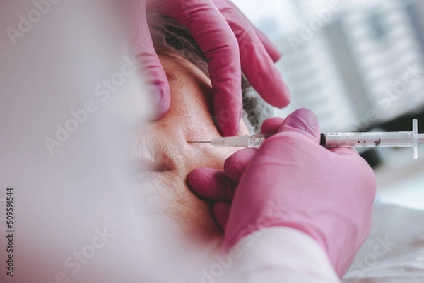 Fototapeta close up hand with glove syringe botox