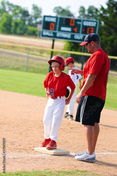 Obraz Baseball player and baseball coach at first base.