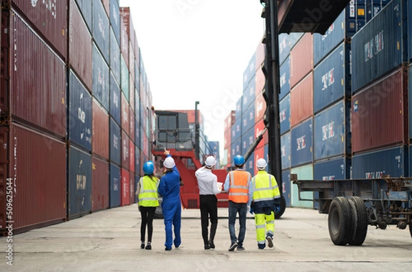 Obraz Dock manager and engineer worker discuss on quality at container shipping yard during truck lifting cargo box. Import and export product. Manufacturing transportation and global business concept