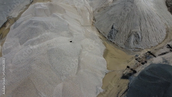 Fototapeta An aerial view of the piles of fine stone in the quarry. Fine stone is used in the production of quality asphalt for roads and for the preparation of concrete used in construction