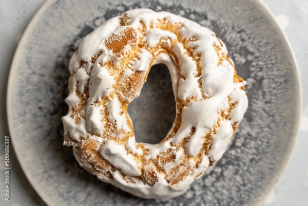 Fototapeta Airy cookies, decorated with white meringues on, light background.Appetizing portuguese pastries on a plate