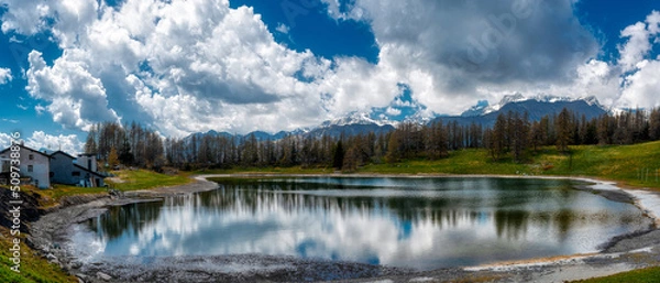 Fototapeta Alpine lake in spring season with clouds in the blue sky