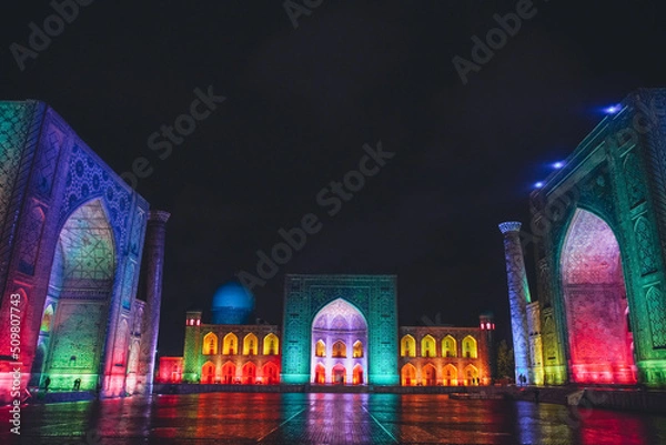 Obraz Registan square in Samarkand lit in colourful lights, Uzbekistan
