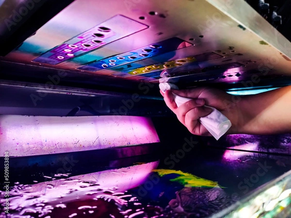 Obraz technician cleaning the print head