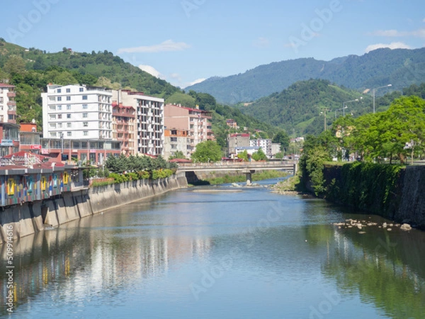 Obraz Shore of a small Turkish town. Provincial quiet town. architecture on the river.