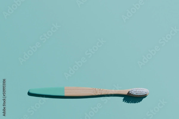 Obraz Bamboo Toothbrush on blue background, organic eco wooden toothbrush with copy space