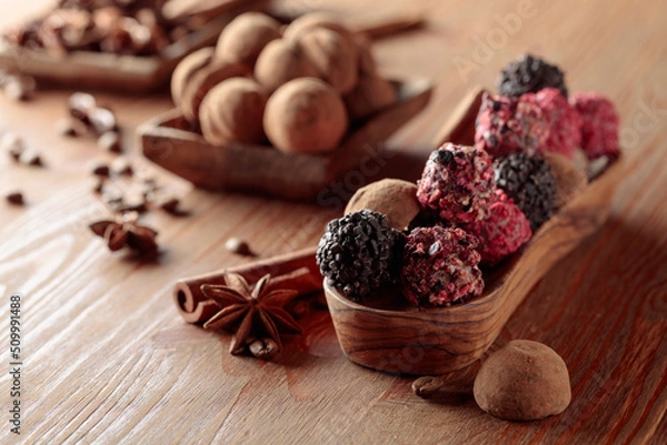 Obraz Chocolate truffles on a wooden table.