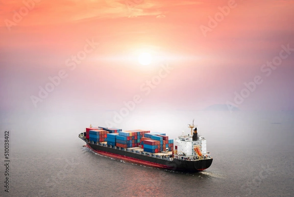 Fototapeta Container ship in the ocean at sunset sky background with copy space, Global business logistics import export goods of freight carrier, cargo transportation industry concept, Sea Freight Shipping