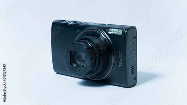 Fototapeta Photo of a vintage pocket camera with open lens on a white background.
