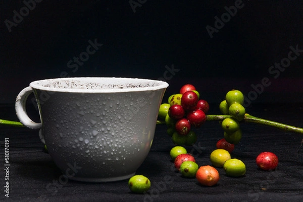 Fototapeta Photo of a cup of black coffee and fresh original coffee beans on a black background. Perfect for the design elements of the barista, coffee shop and coffee industry.