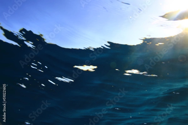 Fototapeta ocean underwater rays of light background, under blue water sunlight