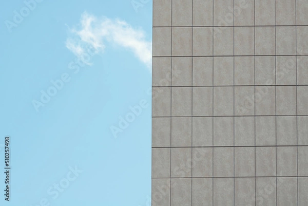 Obraz Abstract architecture. Close up of a modern building with blue sky.