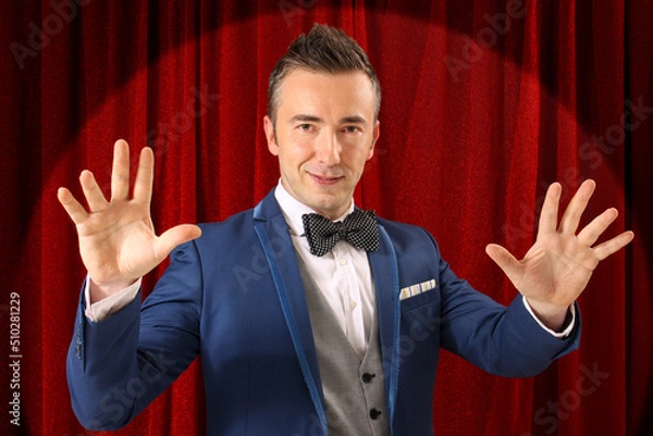 Fototapeta Magician performing act of magic and illusion