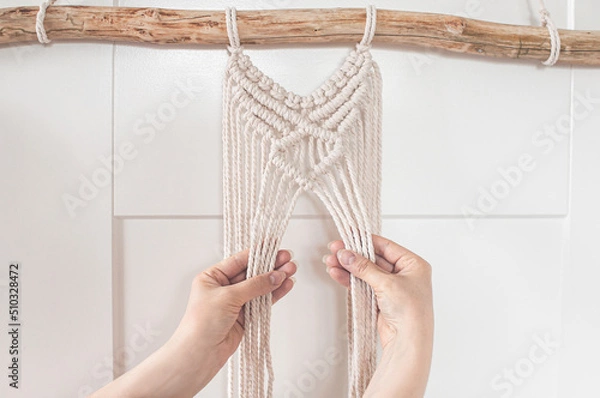 Obraz Girl weaving a macrame pattern for a large wall panel