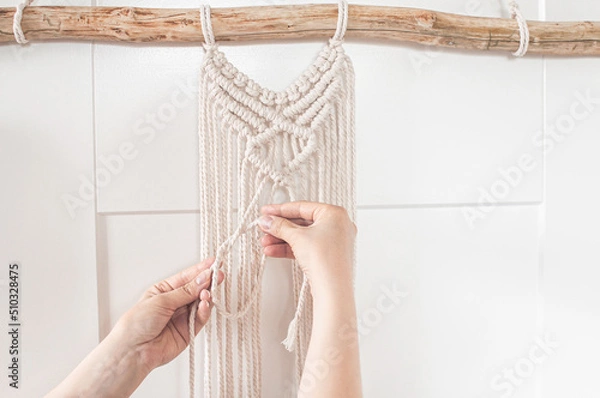 Obraz Girl weaving a macrame pattern for a large wall panel