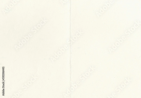 Fototapeta Large image of paper texture background folded in half with aged, uncoated fine fiber grain and dust particles in light beige yellowed color smooth with copy space for text wallpapers or designs