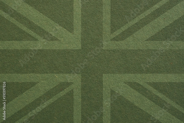 Fototapeta British flag outline on green cardboard surface. Paper texture with cellulose fibers. Dark olive paperboard wallpaper or background. The official symbol of the Great Britain
