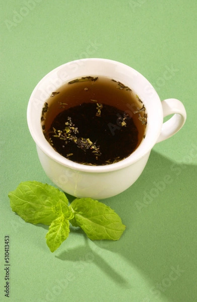 Fototapeta hot tea with mint on a blue background