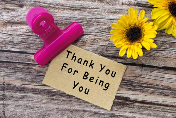 Fototapeta Thank you for being you text on torn paper with clip holder on wooden surface.