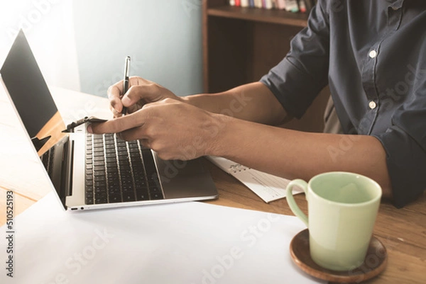 Fototapeta Young entrepreneur business owner work at home, small business startup receive order client and take note working with report and pack the product on purchase delivery online to sending destination.
